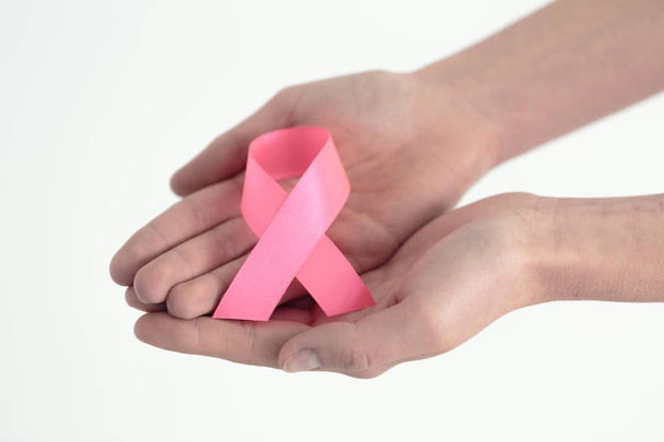Hands presenting pink ribbon - Foto, afbeelding