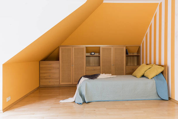 Modest bedroom at the attic - 写真・画像