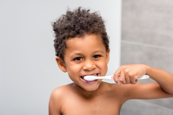 afro lapsi harjaamalla hampaat
 - Valokuva, kuva