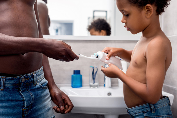 father and son brushing teeth - Photo, Image