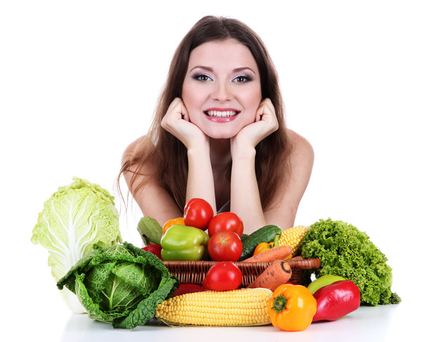 Beautiful woman with vegetables on table isolated on white - Foto, imagen