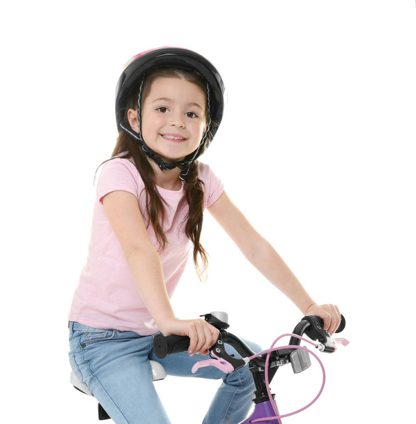 Cute little girl riding bicycle on white background - Zdjęcie, obraz