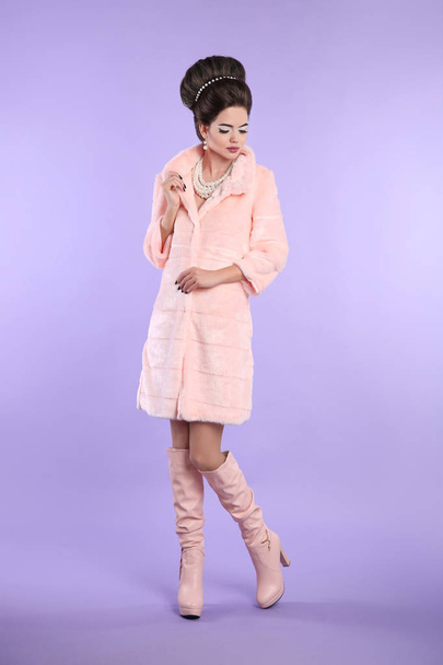Fashion photo of fashionable woman in pink coat with elegant hai - 写真・画像