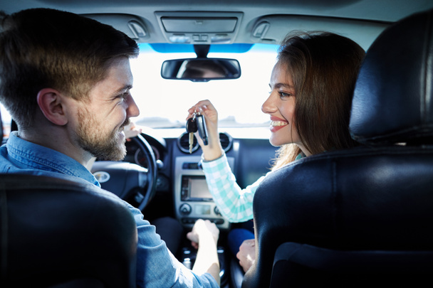 woman with man sitting in new automobile  - Photo, Image