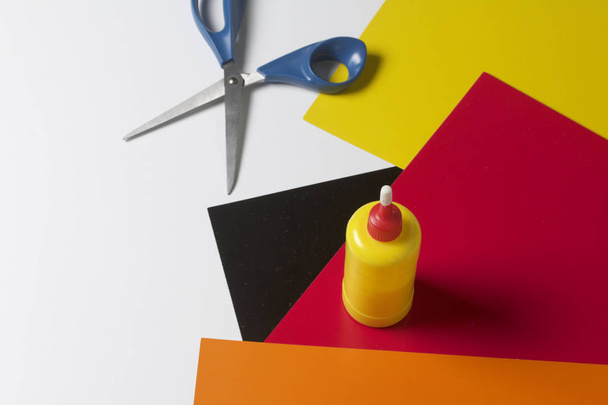 School accessories for creativity. Color paper, glue and scissors for applique. On a white background. - 写真・画像