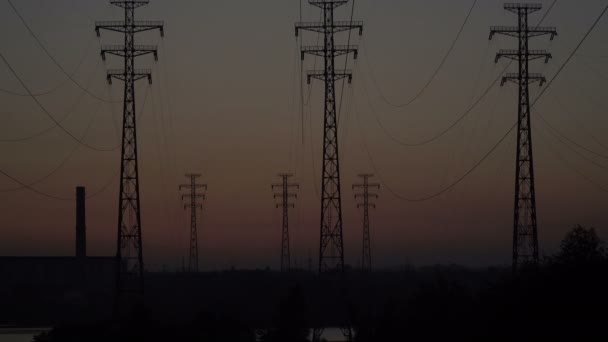 High-voltage power lines at sunrise. - Footage, Video