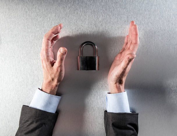 protecting businessman hands questioning corporate data security and safety - Foto, Imagem