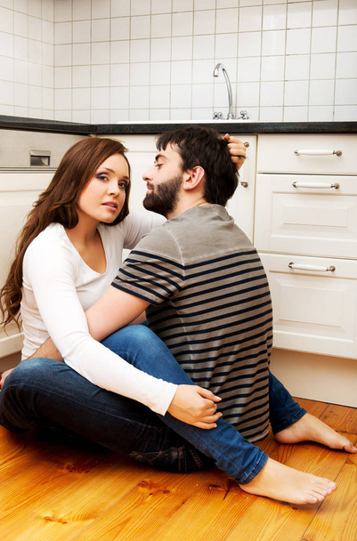 Romantic couple hugging in the kitchen. - Valokuva, kuva