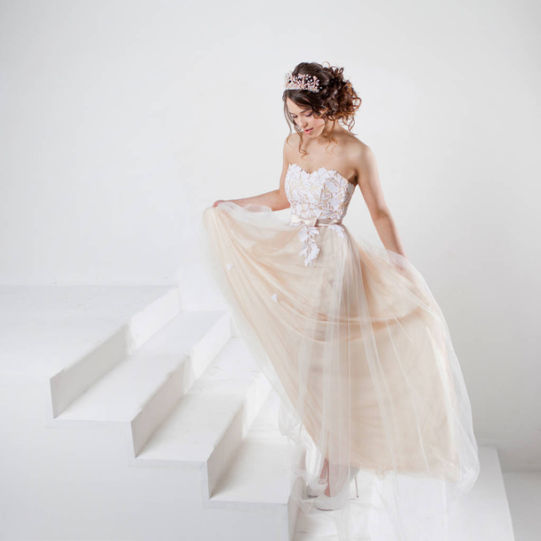 Portrait of a beautiful girl in a wedding dress. Dancing Bride, white background. - 写真・画像