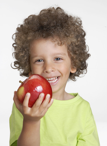 Little kid holding a red apple,eating apple. - Fotoğraf, Görsel
