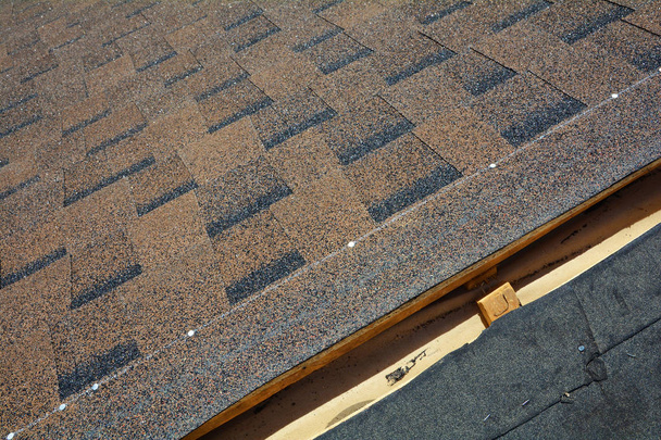 Installing Bitumen Roof Shingles. Roof Shingles - Roofing. - Photo, Image