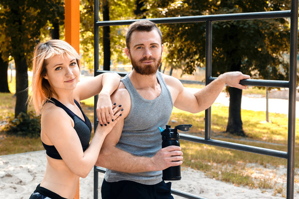 Sporty blonde girl and bearded man is resting after workout trai - Fotografie, Obrázek