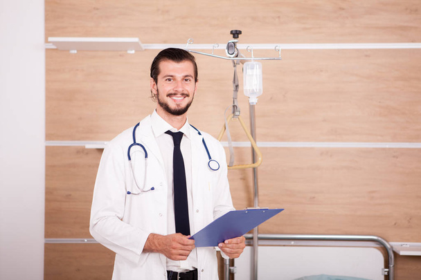 Medic holding a folder in hands with stethoscope arround his nec - Zdjęcie, obraz