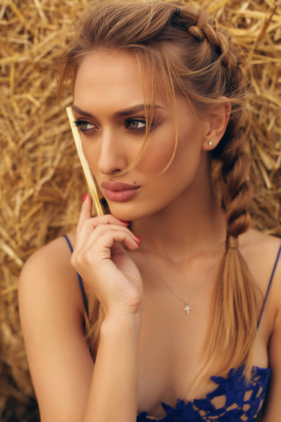 girl with blond hair in elegant dress posing on the hay - Photo, Image