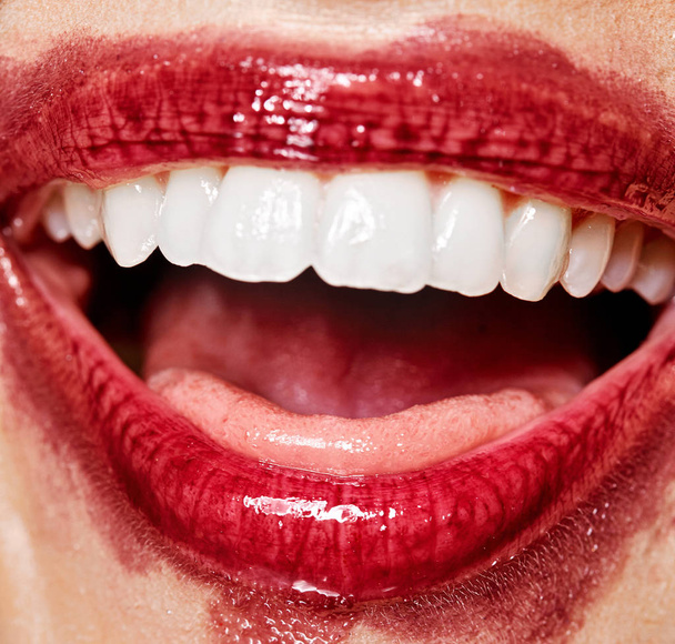 Sexy lips smile with white teeth the smeared lipstick . Open mouth with white teeth. Cosmetology, drugstore or fashion makeup concept. Beauty studio shot. - Фото, зображення
