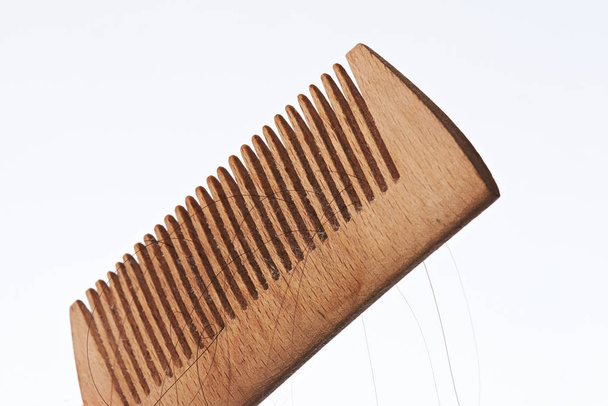 Wooden comb with dark hair strands - Photo, Image