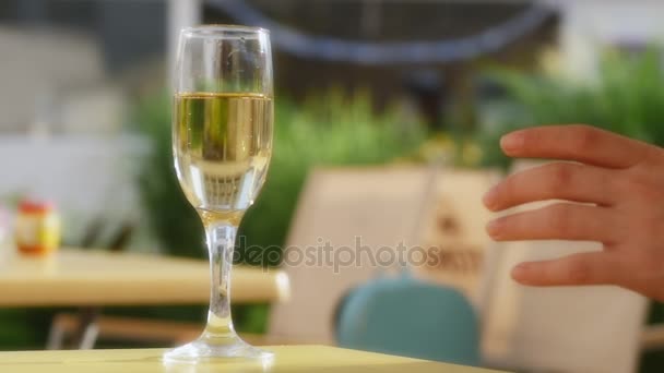 Hand raising a glass of champagne. Bubbles close-up. Slowe motion. - Video