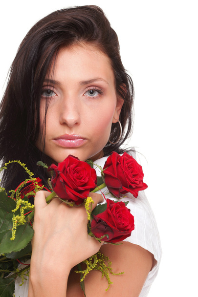 Closeup portrait of attractive young woman holding a red rose - Fotoğraf, Görsel
