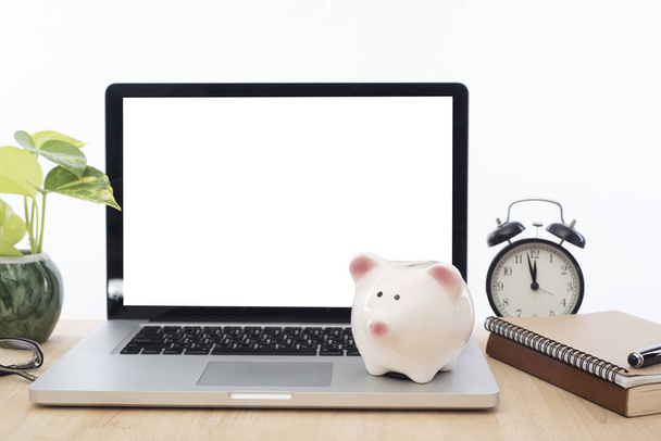 workplace with piggy bank and modern computer white screen  - Фото, изображение
