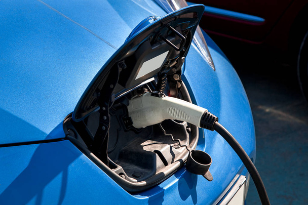 Charging an electric car, close up. - Foto, afbeelding