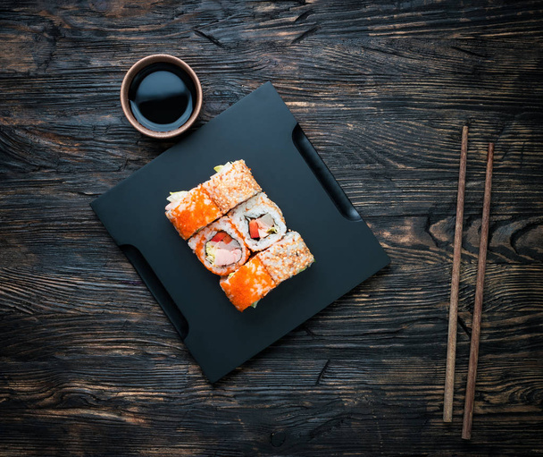 set of sushi rolls with soy and chopsticks - Foto, Imagem