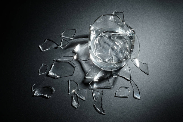 A breaking glass of water on the black background - Photo, Image