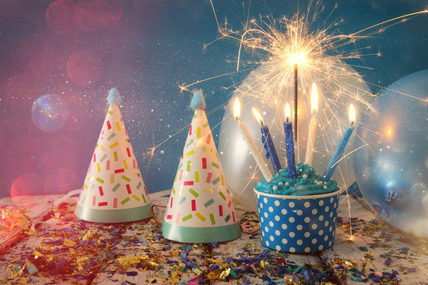 Birthday concept with cupcake and candles on wooden table - 写真・画像