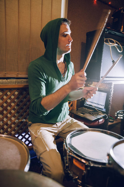 Male drummer playing drums in recording studio - 写真・画像