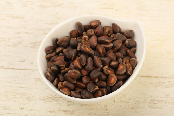 Cedar nuts in the bowl - Фото, изображение