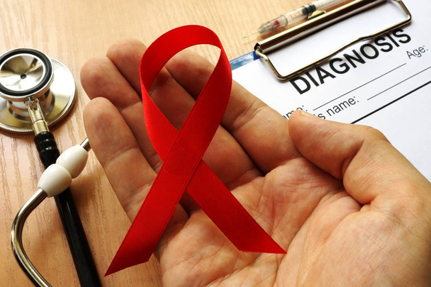 Symbol of HIV/AIDS. Red awareness ribbon. - Фото, зображення