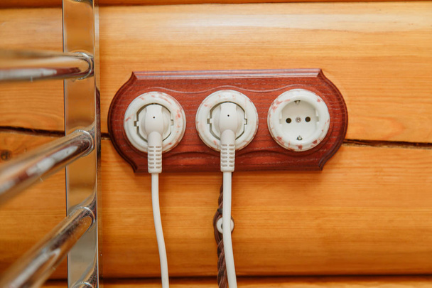 Interruttori elettrici vecchio stile, presa, filo elettrico su una parete di legno
. - Foto, immagini