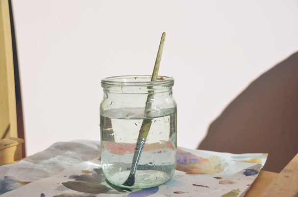 Paintbrush in jar with clean water  - Photo, Image