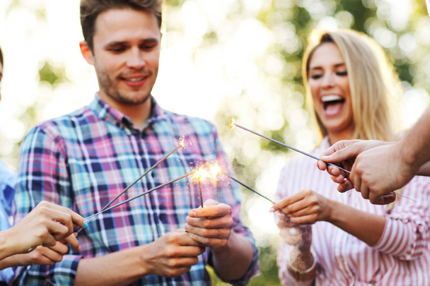 friends having fun with sparklers - Photo, Image