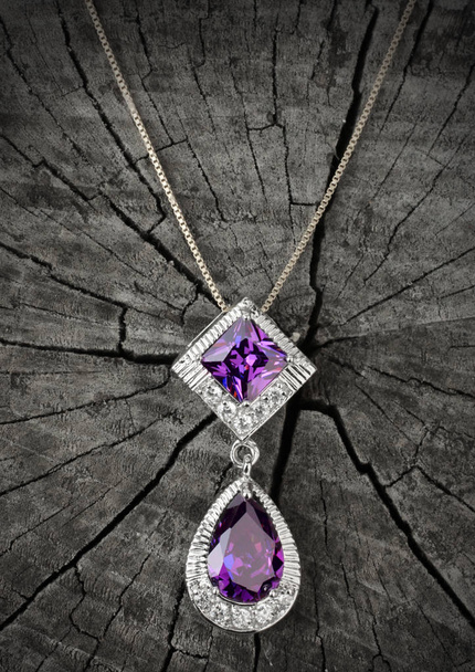 Jewelry pendant with tourmaline on black wood background - Foto, afbeelding
