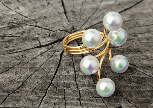 Jewelry ring with pearl on grey wood background - Valokuva, kuva