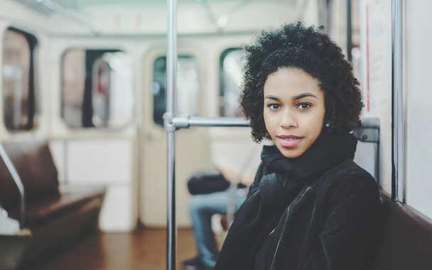 Female teenager on the seat of underground train - Фото, изображение