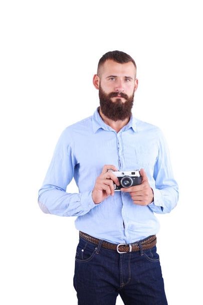 Portrait of a young photographer with a camera, isolated on white background - Фото, зображення