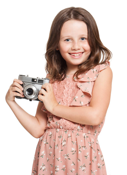 Young brunette girl with vintage camera. - Фото, изображение