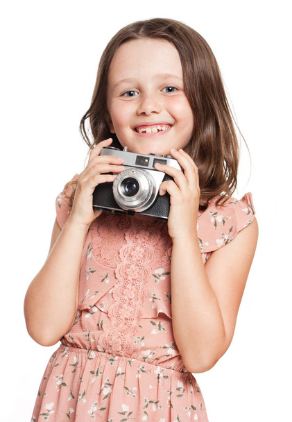 Young brunette girl with vintage camera. - 写真・画像
