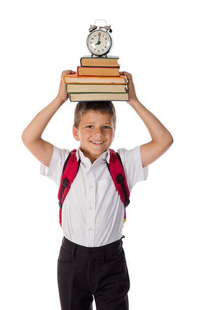 Happy schoolboy standing with book on head - Foto, imagen