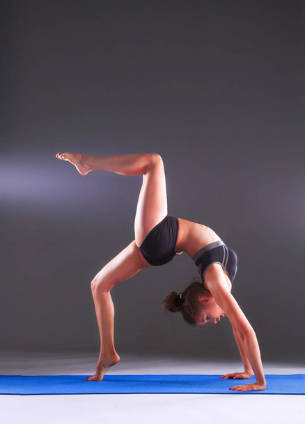 Portrait of sport girl doing yoga stretching exercise - Photo, image