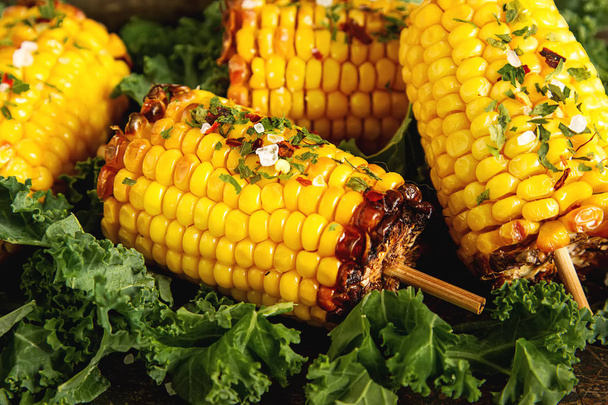 Corn grilled with salt and spices. Dark background. Fast food in - Zdjęcie, obraz