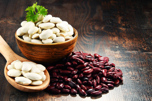 Composition with bowl of beans on wooden table - Photo, Image