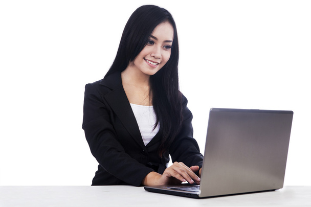 Business woman work with laptop isolated in white - Foto, imagen