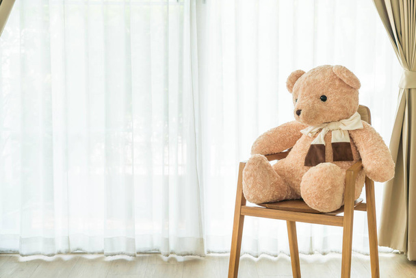 bear doll on chair - Фото, изображение