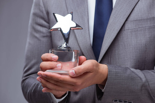 Businessman holding star award in business concept - Photo, Image
