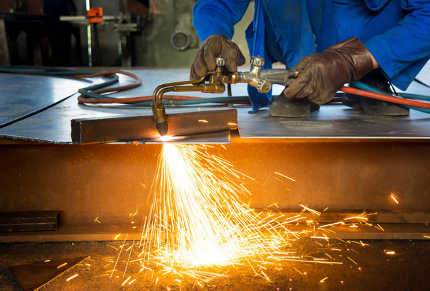 Man cutting metal with a welding cutting torch - Photo, Image