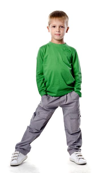 Full length portrait of a happy little boy standing isolated ove - Foto, imagen