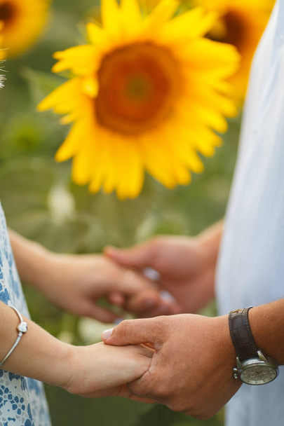 Couple in love in the field of romantic sunflowers - Photo, Image