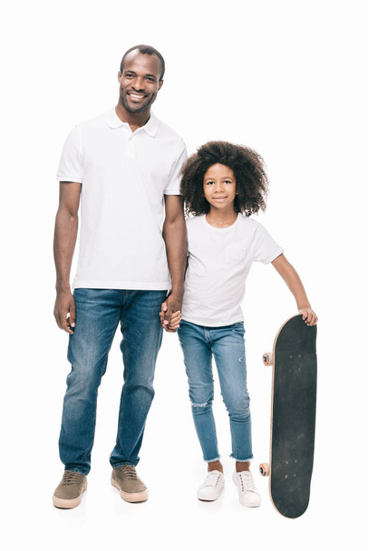 happy father and daughter with skateboard - Zdjęcie, obraz